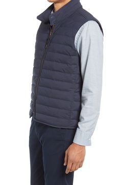 Lightweight insulation warms this outdoors-inspired vest built with a water-resistant shell that offers a hint of stretch for enhanced comfort. 86% nylon, 14% spandex Machine wash, tumble dry Imported Navy Nylon Functional Outerwear, Functional Stretch Nylon Outerwear, Fitted Nylon Vest For Cold Weather, Fitted Quilted Nylon Vest, Nylon Vest For Layering In Fall, Fall Nylon Vest For Layering, Athleisure Sleeveless Outdoor Outerwear, Fall Layering Nylon Vest, Sleeveless Athleisure Outdoor Outerwear