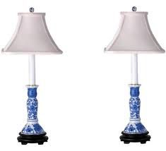 pair of blue and white porcelain lamps with shades on each lamp shade, one in the shape of an elephant