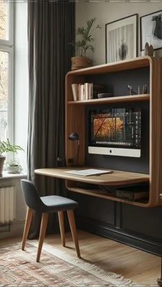 a desk with a computer on top of it in front of a window next to a chair