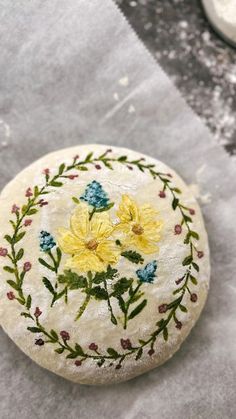 a painted rock with yellow flowers on it