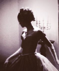 a black and white photo of a woman in a dress