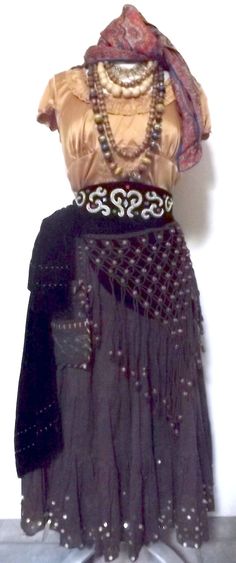 a woman's skirt and top with beaded details on the bottom is shown