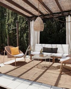 an outdoor living area with wicker furniture