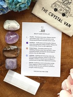 some rocks and flowers on a table with a note that says the crystal van next to it