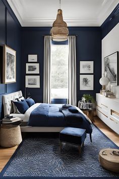 a bedroom with dark blue walls and white furniture, including a large bed in the center