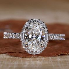 Close-up of 1 Carat Oval Diamond Ring with Halo Setting Oval Diamond Ring With Halo, Oval Wedding Rings, Oval Halo Diamond Ring, Oval Cut Diamond Rings, Oval Halo Engagement Ring, Moissanite Vs Diamond, Oval Engagement Ring, Colored Diamond Rings, Pave Diamond Band