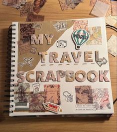 a notebook with the words my travel scrapbook surrounded by pictures and magnets on a wooden table