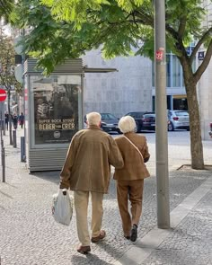 an older couple walking down the street