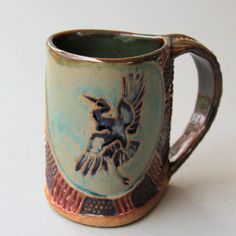 a ceramic mug with a bird on it