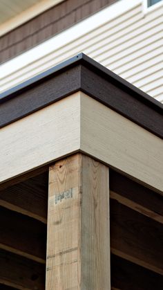 a close up of the top of a wooden post on a house's roof