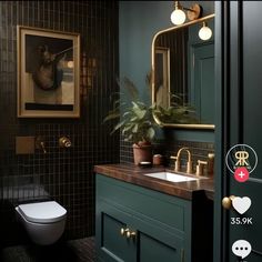 a bathroom with green walls and gold fixtures