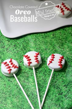 three baseball cake pops sitting on top of green grass