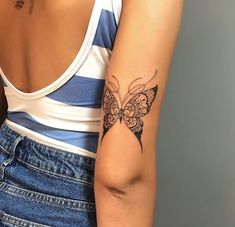 a woman with a butterfly tattoo on her arm