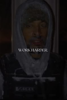 a man wearing a hoodie with the words work harder in front of his face