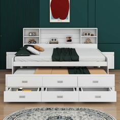 a white bed with drawers underneath it and a rug on the floor next to it