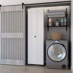 a laundry room with a washer and dryer next to each other in front of an open door