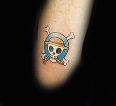 a skull and crossbones tattoo on the left arm, with a pirate hat