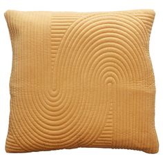 a yellow pillow with wavy lines on the front and back, against a white background