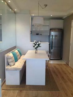 a kitchen with a table, bench and refrigerator in it's centerpieces