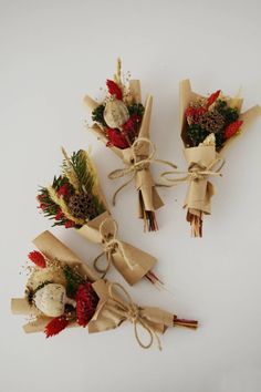 four bouquets of flowers tied together with twine