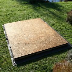 a large piece of plywood laying on the grass