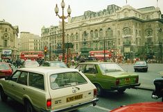 many cars are driving down the busy street