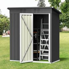 a storage shed with its doors open on the grass