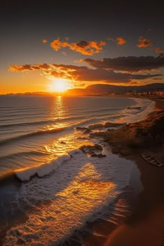 the sun is setting over the ocean and beach