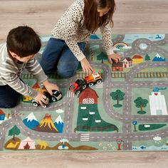 two children playing with toys on the floor