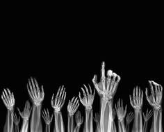 a group of hands reaching up into the air with their fingers extended in front of them