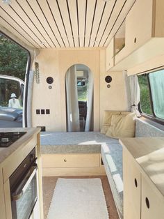 an interior view of a camper van with the kitchen and living room in it