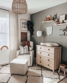 a baby crib in the corner of a room with furniture and decor on it