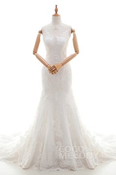 a white wedding dress on display in front of a mannequin's head