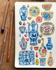 an open notebook with many different colored vases on it and two pencils next to it