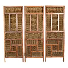 a set of three wooden shelves with wicker doors