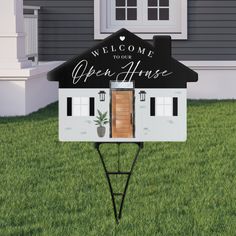 an open house sign in front of a home with the words welcome to your open house written on it