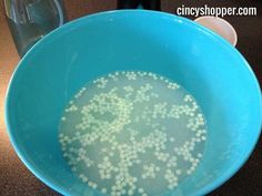 a blue bowl filled with water on top of a table