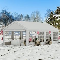 a white gazebo in the snow with pink balloons on it's roof and windows