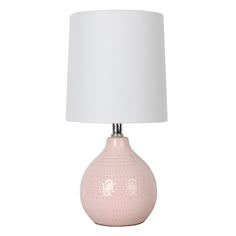 a pink ceramic table lamp with a white shade on the base and a white fabric lampshade