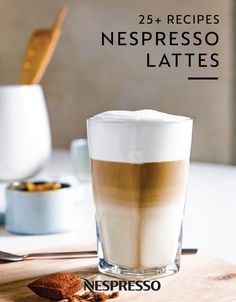 a cup of coffee sitting on top of a wooden table