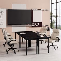 a conference table with chairs and a television mounted to the wall