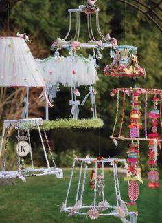 an assortment of hanging items in the shape of lamps and chandeliers on display