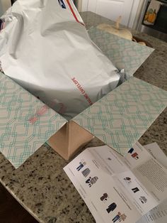 an open bag sitting on top of a counter next to some papers and other items