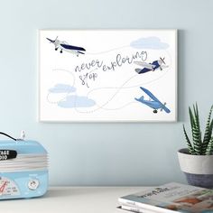 a blue suitcase sitting on top of a white table next to a potted plant