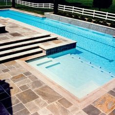 an empty swimming pool with steps leading up to it