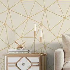 a living room with gold geometric wallpaper