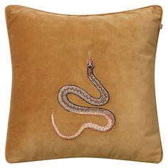 a brown pillow with a snake embroidered on it