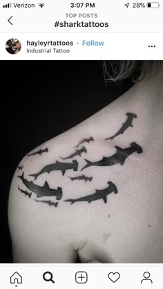 a woman's back shoulder with black ink on it, and the words shark tattoos below