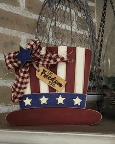 a patriotic hat is sitting on top of a shelf next to a birdcage