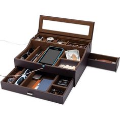 an open wooden box containing several compartments for cell phones and other electronic gadgets